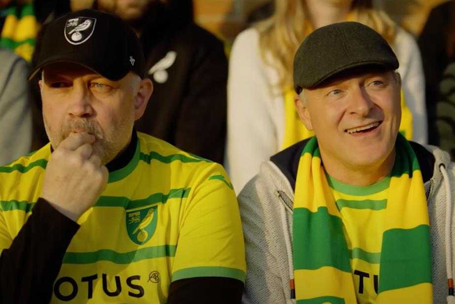 Two football fans at a game together